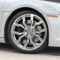 Close-up of a silver Audi wheel showing alloy rim, brake disc and caliper behind it.